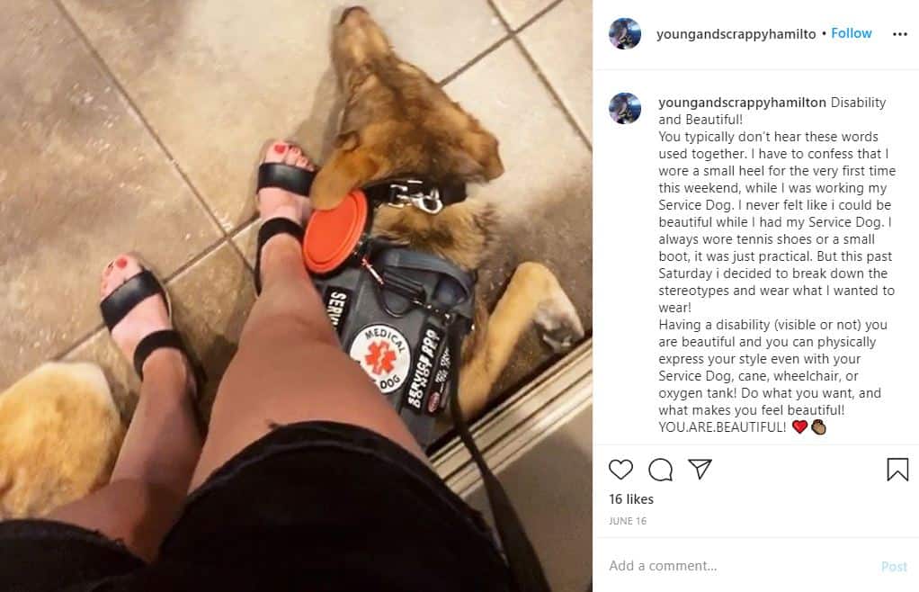 An image from the Instagram of Young and Scrappy Hamilton. Picture shows hamilton, a service dog, laying down at the feet of his owner. 